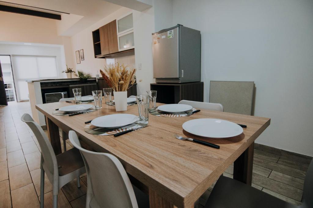 a wooden table in a kitchen with a dining room at Mendoza Apartments in Mendoza