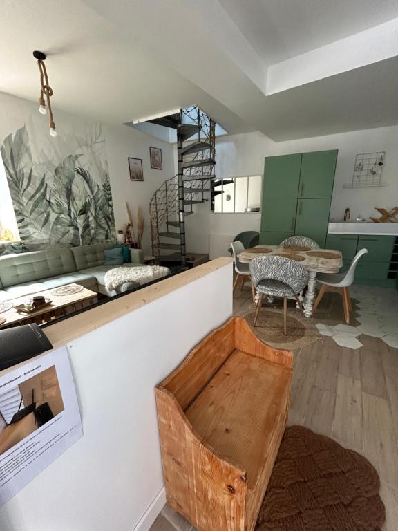 a living room with a counter and a table at Petite maison dans village animé in Jaulgonne