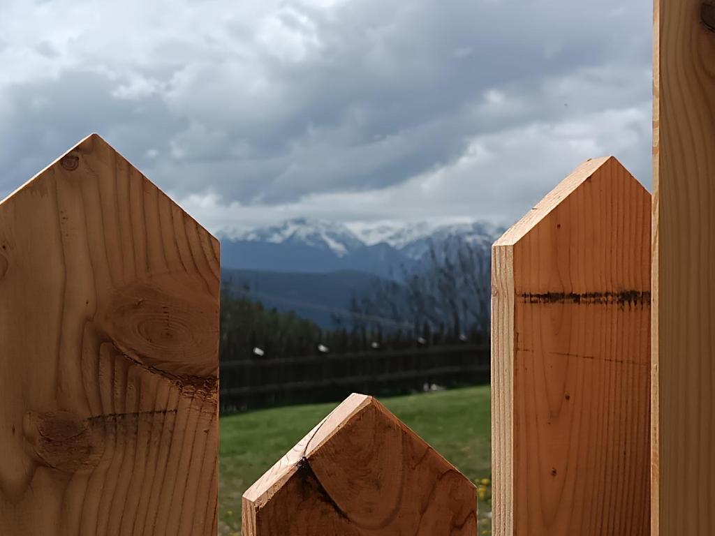 a pair of wooden fences with mountains in the background at Ferienwohnung Marchnerhof in Terento