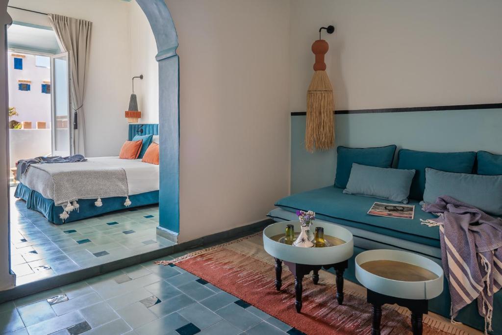 a living room with a couch and a bed at Le Palazzo in Essaouira