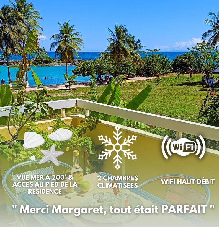a sign for a resort with a view of the beach at Chez Marguerite by MAGCAR in Le Gosier
