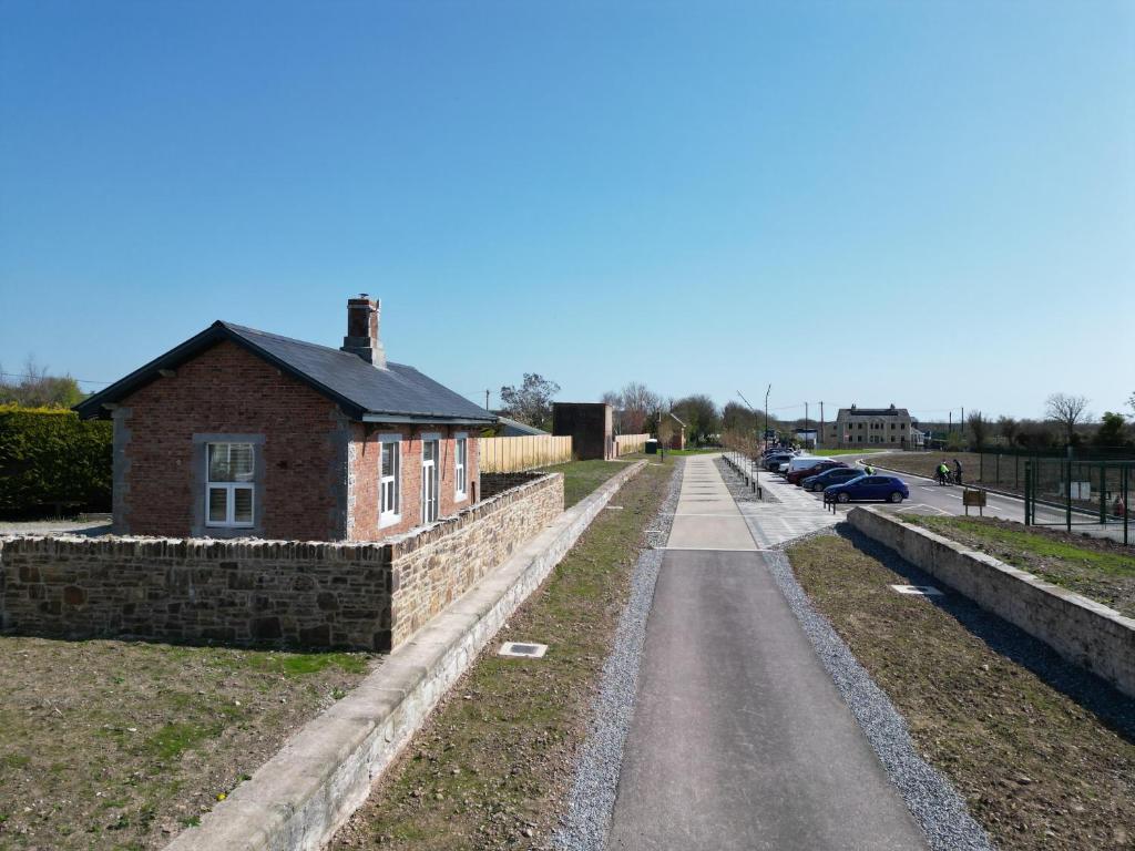 a brick building on the side of a road at Railway Cottage in Cork