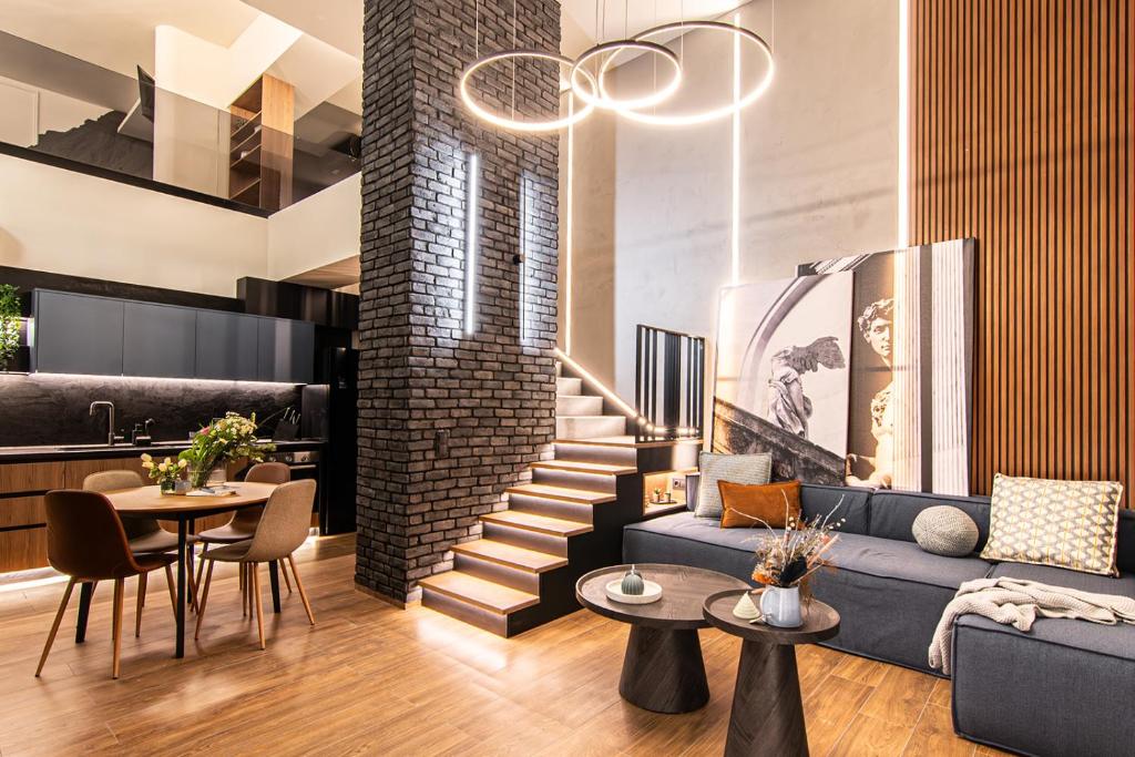 a living room with a couch and a table at MoonLight Lofts APHRODITE & POSEIDON in Alexandroupoli