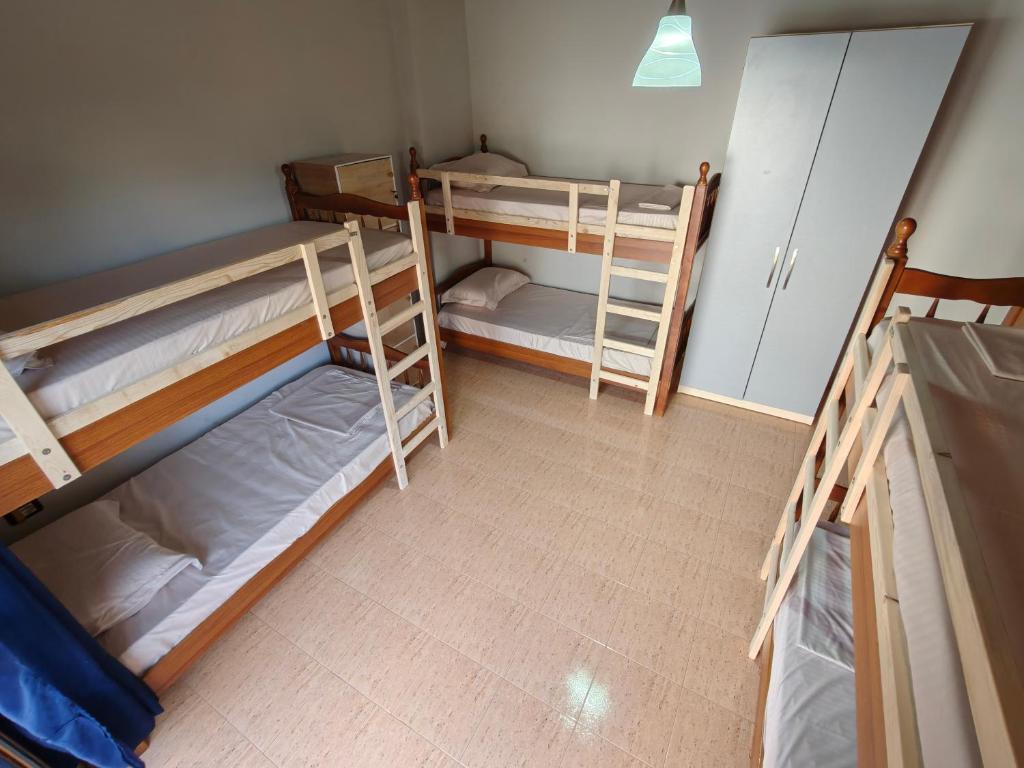 Postel nebo postele na pokoji v ubytování Bliss Inn Hostel & Tours