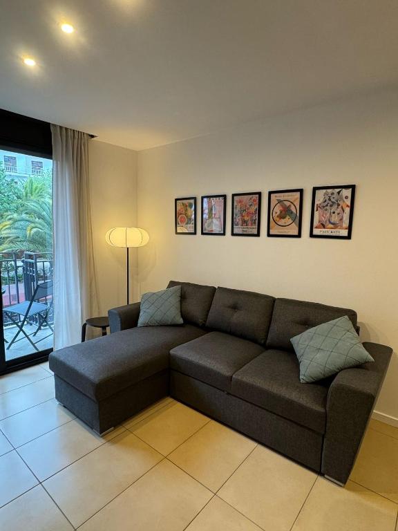 a living room with a couch in a room at Cala Paula in Lloret de Mar