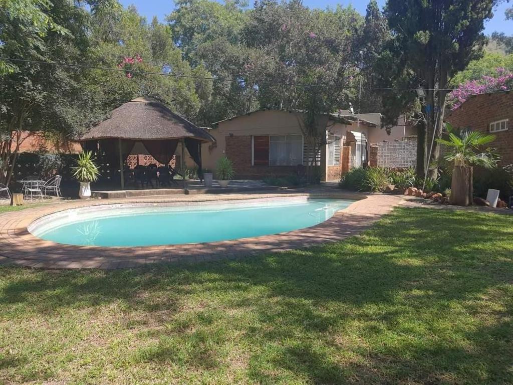 a swimming pool in the yard of a house at Chalet 6 At Cynthias Country in Hartbeespoort