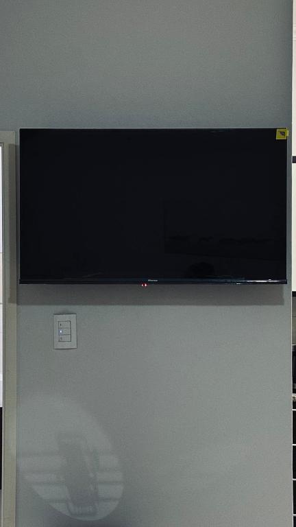 a flat screen tv sitting on top of a wall at Cosy Urban Apartment in Durban
