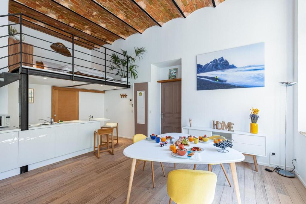 une cuisine et un salon avec une table et des chaises dans l'établissement GUBERNATIS - Beautiful Duplex with terrace, à Nice