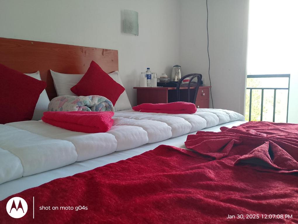 Postel nebo postele na pokoji v ubytování T-More Hotel & Hostel