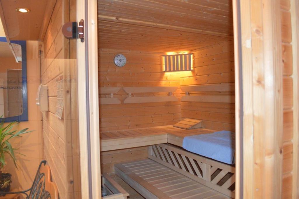 a wooden sauna with a bench in the middle at Ferien-und Bauernhof Gauster in Trebel