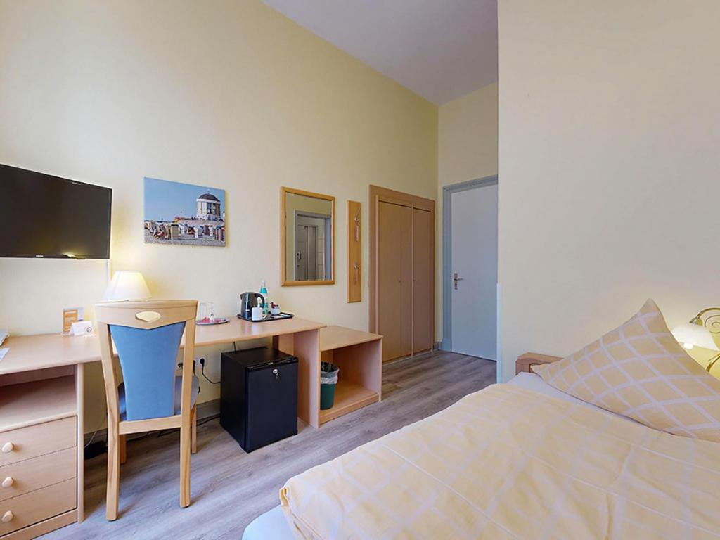 Postel nebo postele na pokoji v ubytování Hotel Graf Waldersee