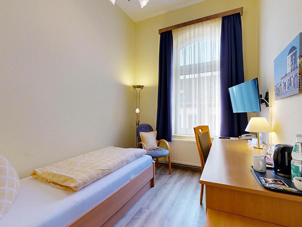 Postel nebo postele na pokoji v ubytování Hotel Graf Waldersee