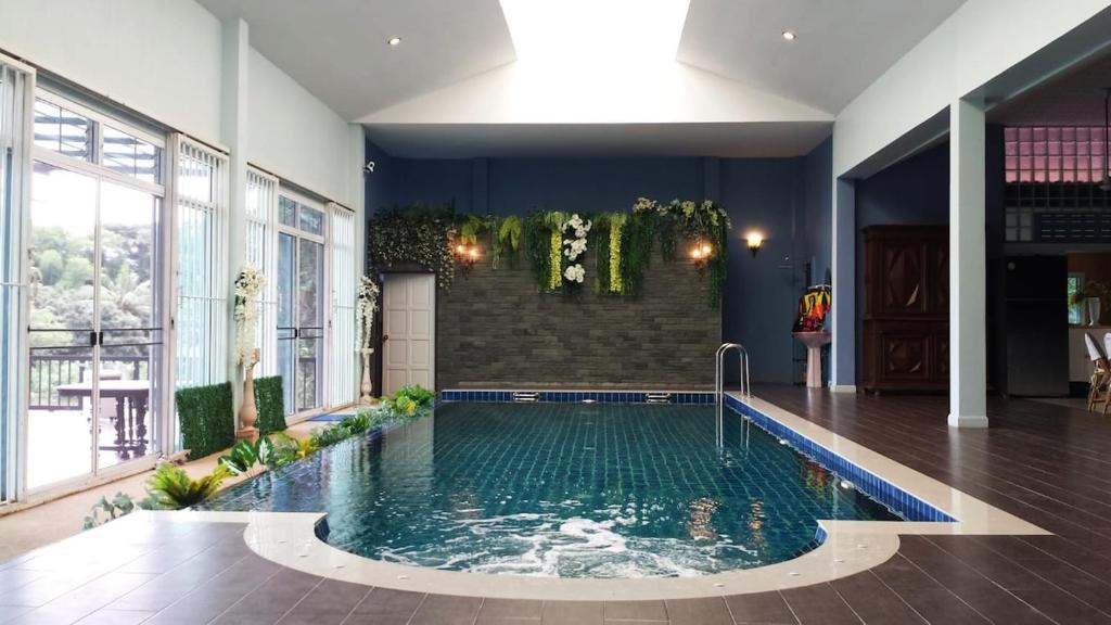 a swimming pool in the middle of a room at Thai River House in Ban Kat Khi Lek