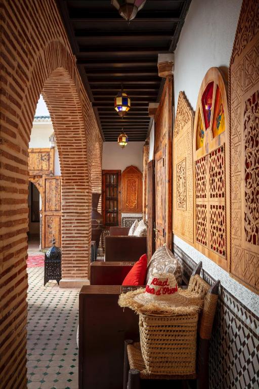 an archway in a room with a couch and tables at Riad Fleur d'Orient in Marrakech