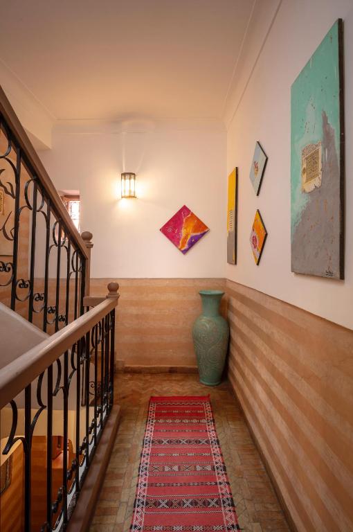a hallway with a staircase with a vase on the wall at Riad Fleur d'Orient in Marrakech
