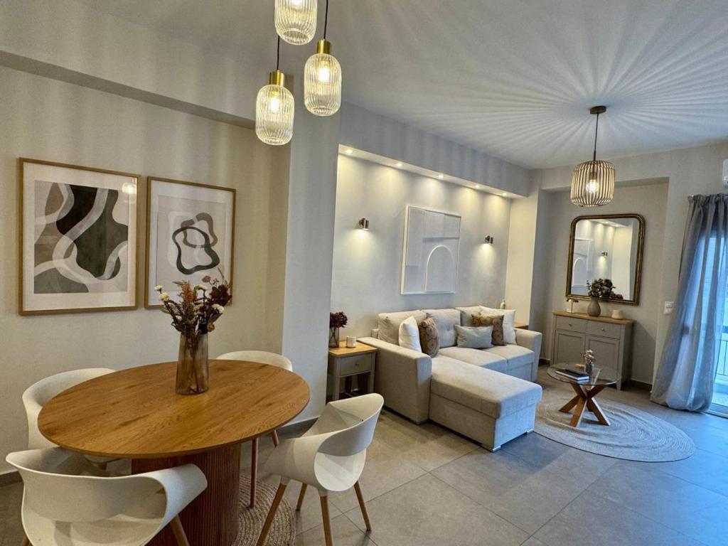 a living room with a table and a couch at Acropoli 1 Bedroom Flat with Rooftop Acropolis View in Athens