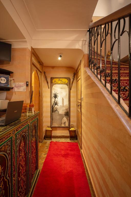 a hallway with a red carpet and a red rug at Riad Fleur d'Orient in Marrakech