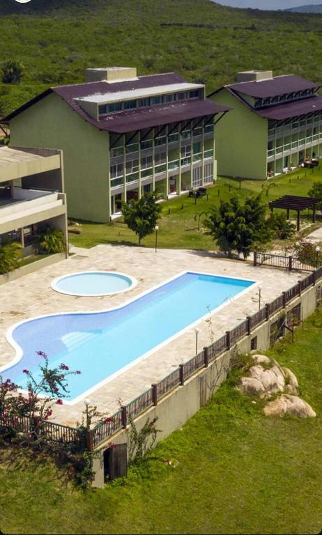 a large swimming pool in front of a building at Flat em Gravatá - Villa Monte Castelo in Sairé