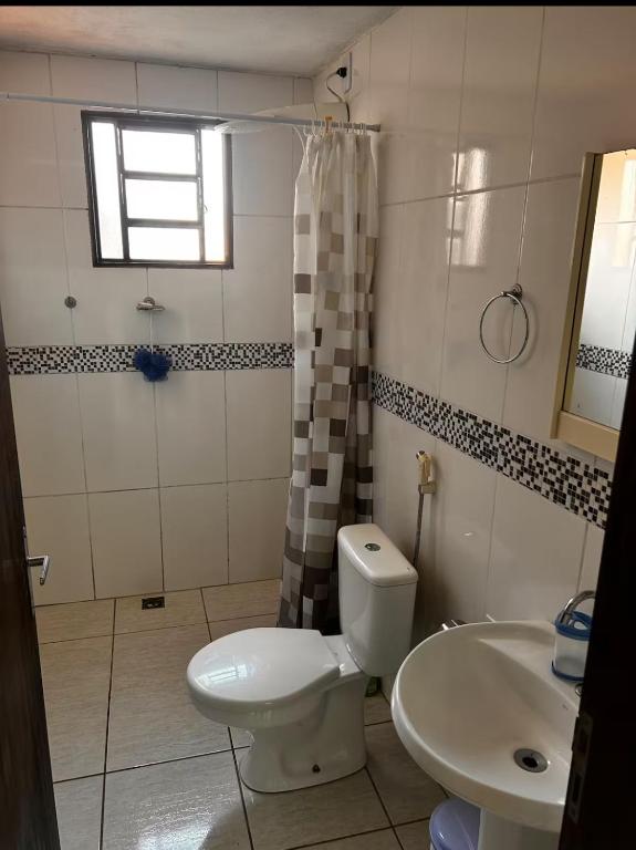 a bathroom with a toilet and a sink at Casa in Socorro