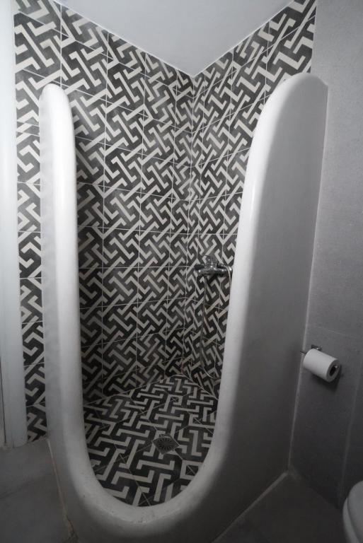 a bathroom with a heart pattern on the wall at Thomas Villas on the beach Katapola in Katapola