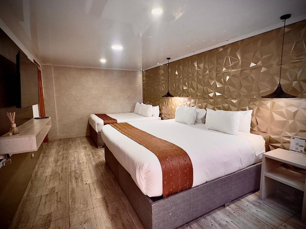 Postel nebo postele na pokoji v ubytování Hotel American Visa Normandia