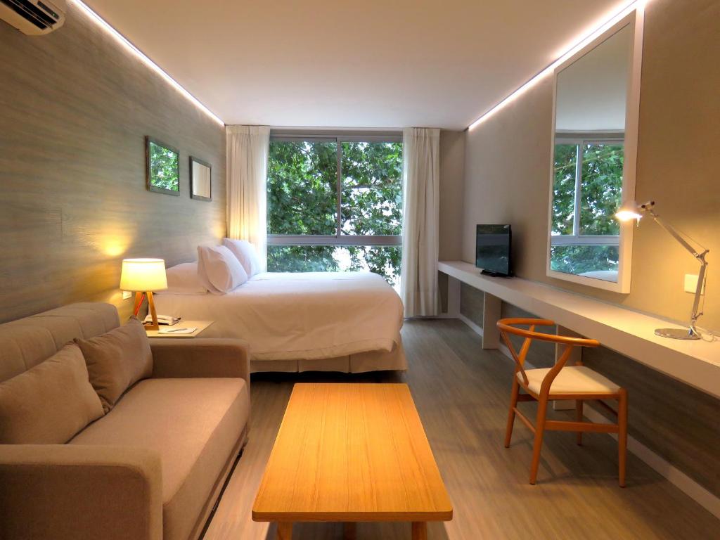 a hotel room with a bed and a couch at Smart Hotel Montevideo in Montevideo