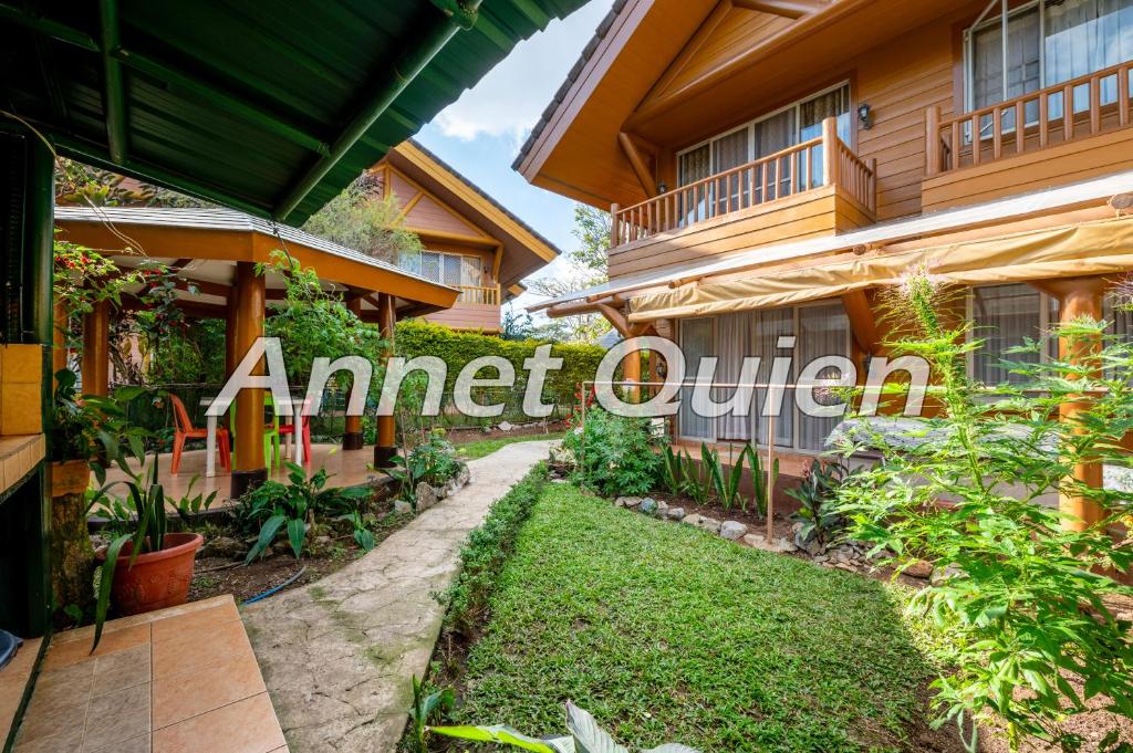 a house with a sign that reads armed outdoor at Camp John Hay 4BR Cabin in Baguio
