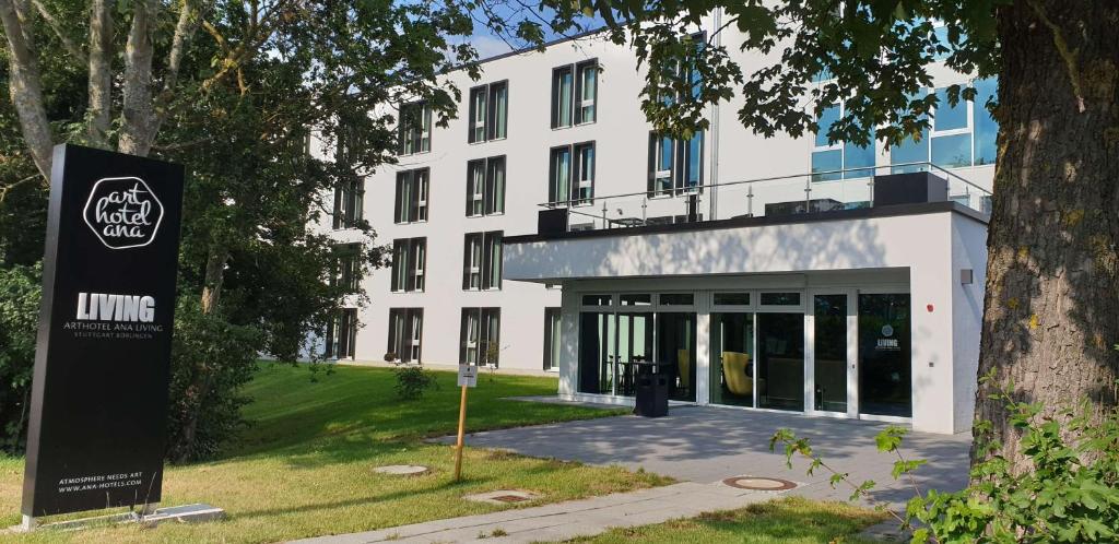 a large white building with a sign in front of it at elaya hotel stuttgart boeblingen in Böblingen
