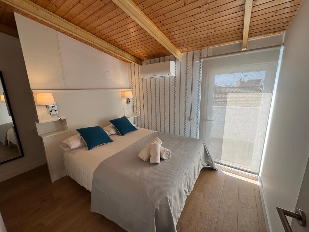 A bed or beds in a room at Apartamentos Pedregalejo Beach Playa