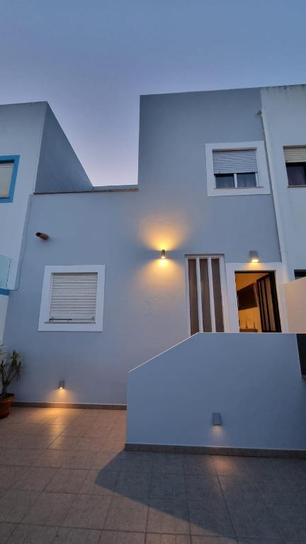 a white building with a large white table in front of it at Casa Yucca in Salema