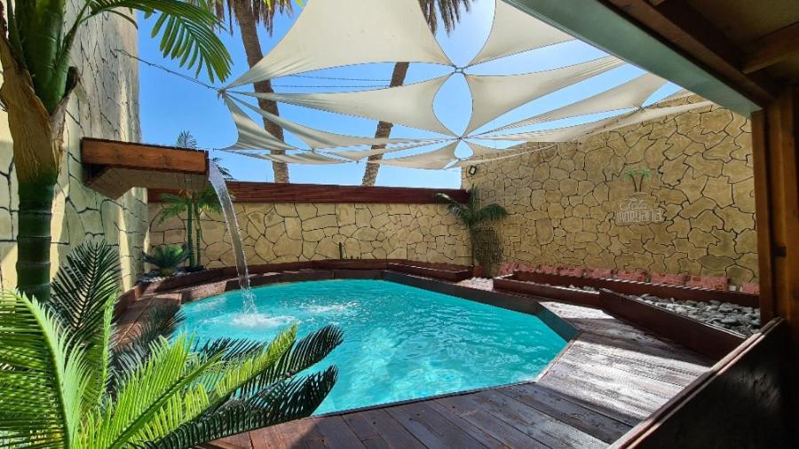 a swimming pool in the middle of a building at Fata morgana Hostel in Beer Sheva