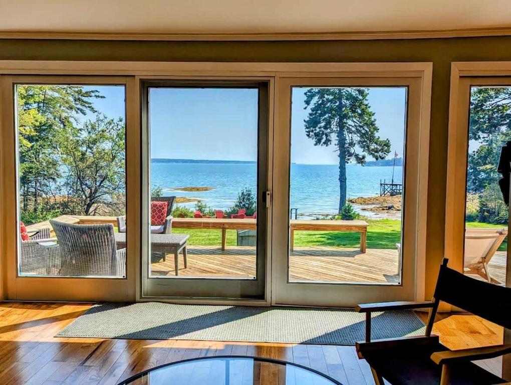 a living room with a view of the ocean at Lone Pine Oceanfront Cottage in Prospect Harbor