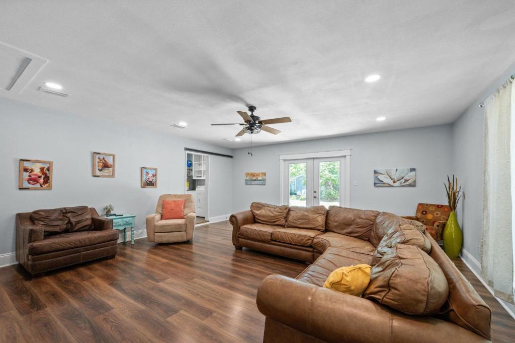 a living room with a couch and a ceiling fan at Peaceful Fairhope Retreat-Large home on 1 acre lot in Fairhope