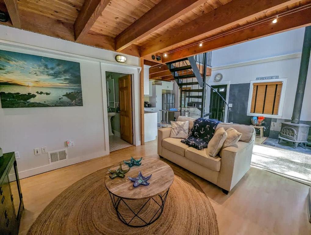 a living room with a couch and a table at Acadia Park Suites Condo in Southwest Harbor