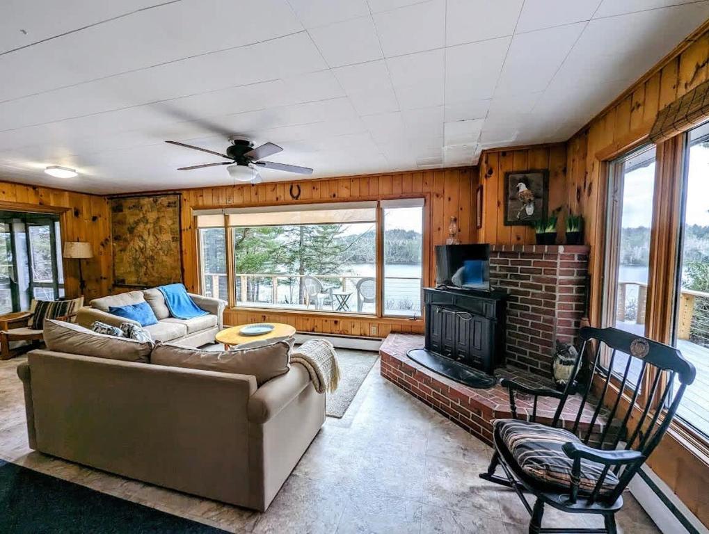 a living room with a couch and a fireplace at Frenchman Bay Oceanfront Getaway in Sullivan