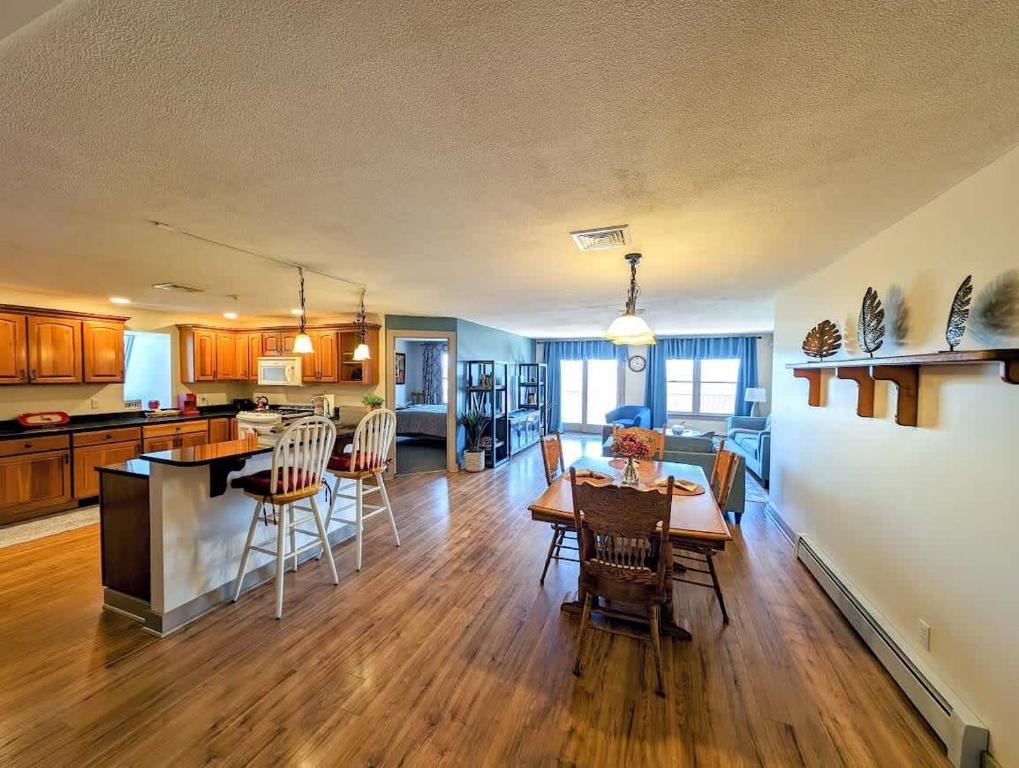 a kitchen and living room with a table and chairs at Acadia Luxury Penthouse Suite in Trenton
