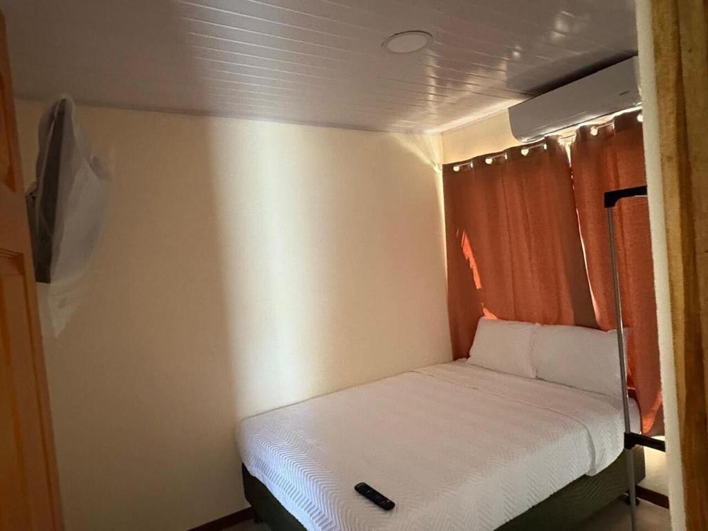 a small bed in a small room on a boat at Bandera Beach Cabins in Parrita