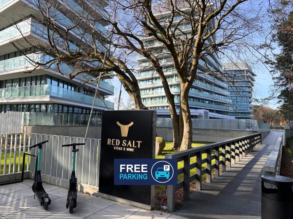 a sign in front of a building with a free parking sign at CREST VIEW 777th - SPA & Seaview Apartment in Międzyzdroje