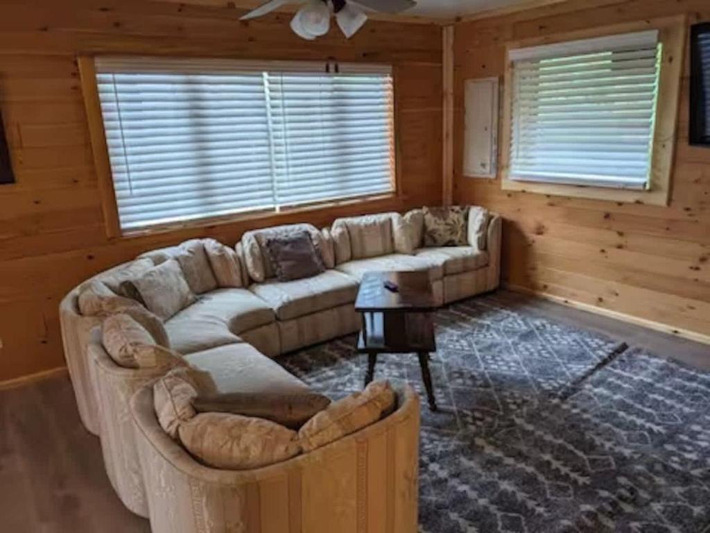 a living room with a couch and a table at Tug Hill Fisherman's Paradise Rural and Quiet - Downstairs in Lacona