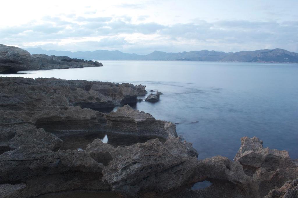 a view of a large body of water with rocks at Hostal Brisa Marina in Port d'Alcudia