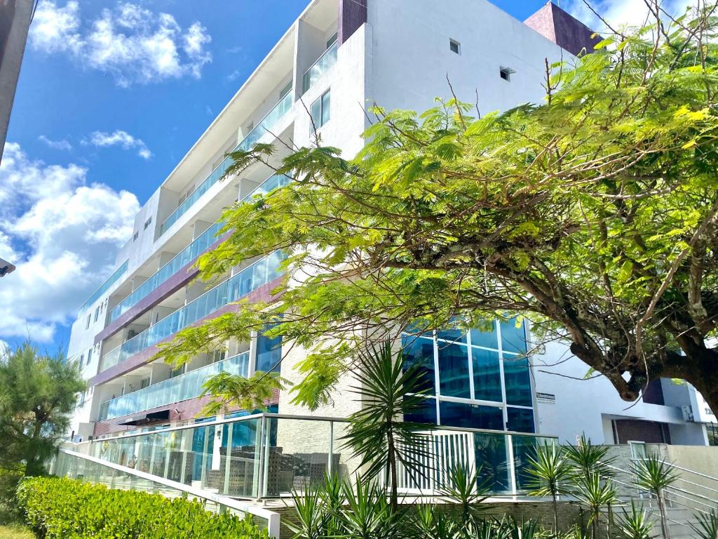 an office building with a lot of windows at Flamboyant Oceania Flats in João Pessoa