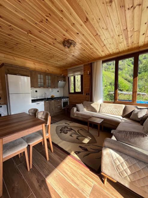 a living room with a couch and a table at Ayder Defne Suit Ev in Çamlıhemşin