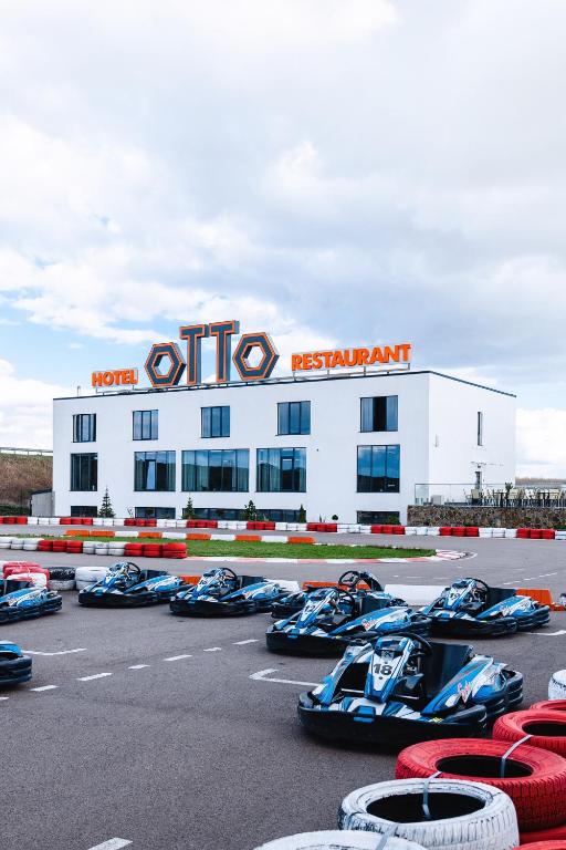 a group of racing cars parked in front of a building at Otto Hotel-Restaurant in Rivne