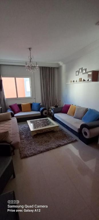 a living room with a couch and a table at Beautiful Apartment in Kantaoui Sousse tourist area in Hammam Sousse