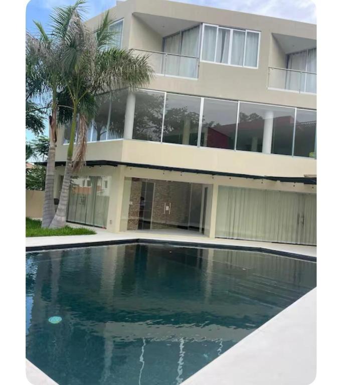 a house with a swimming pool in front of it at Casa cascada candela in Bahías de Huatulco