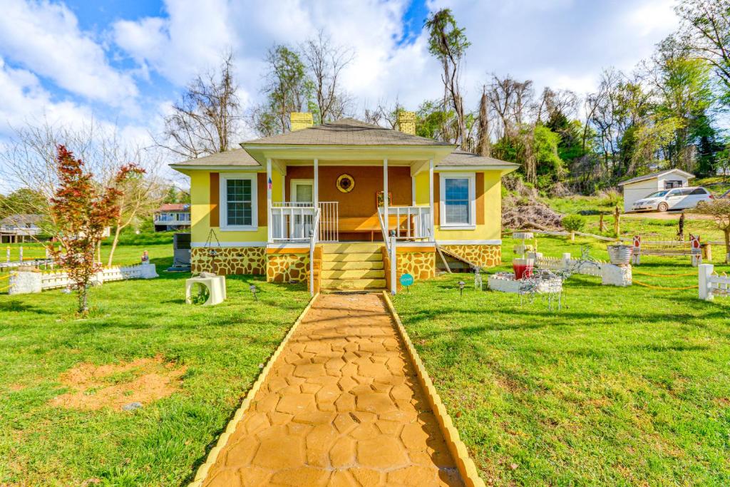 ein gelbes Haus mit einem gemauerten Gehweg im Hof in der Unterkunft Pet-Friendly Home with Grill and Porch in Martinsville in Martinsville