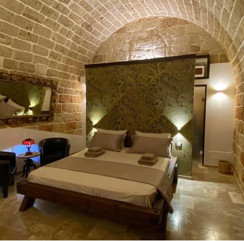 En eller flere senge i et værelse på Suite maXimo con vasca Idromassaggio