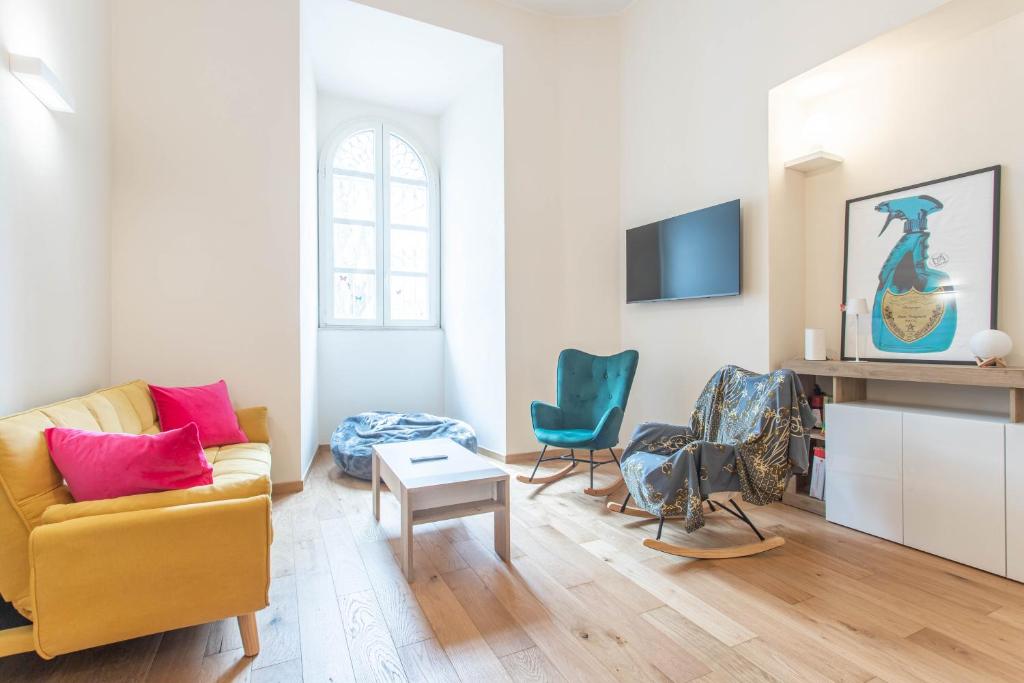 a living room with a yellow couch and two chairs at AM6 - Dimora del Borgo in Perugia