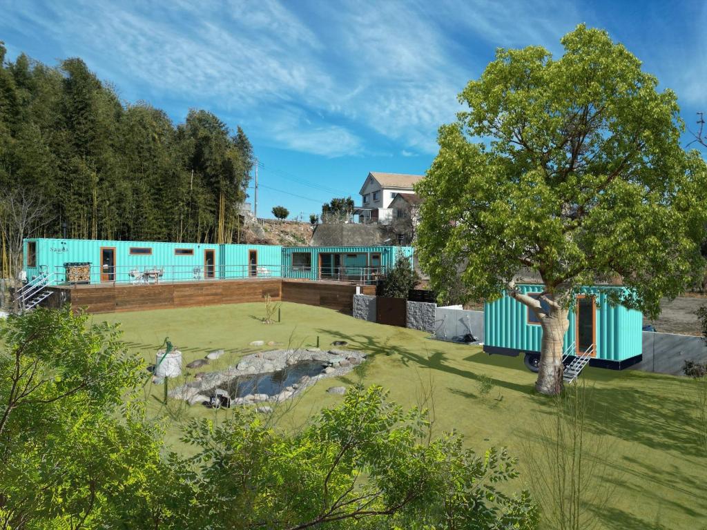 a green yard with a tree in front of a building at THE W Relax Garden Resort - Vacation STAY 09071v in Yoshioka