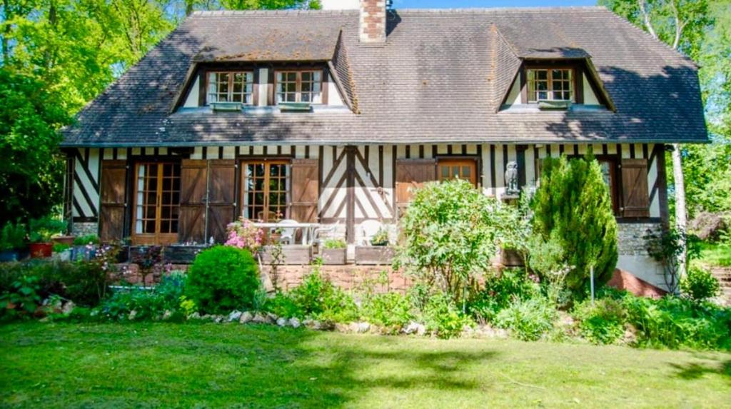 an old house with a garden in front of it at Authentic Norman house in Saint-Cyr-de-Salerne